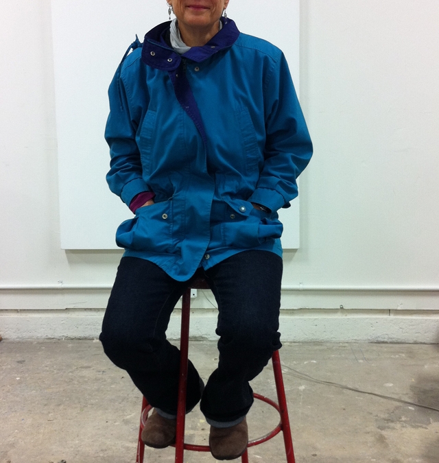 Barbara Downs in studio sitting in front of new large canvas